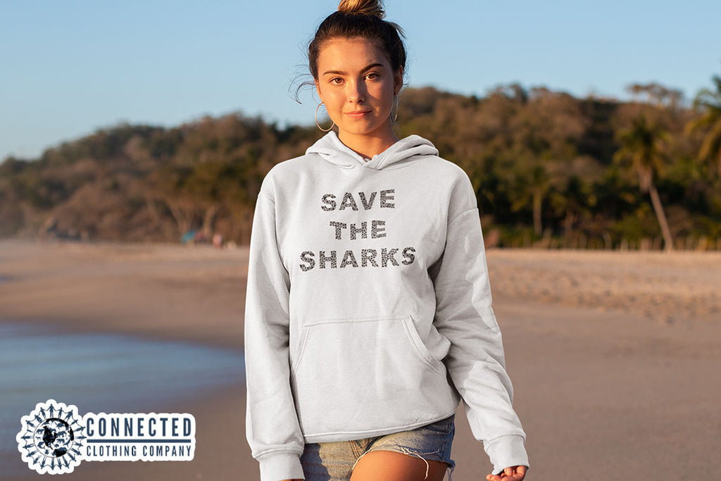 woman on the beach wearing White Save The Sharks Unisex Hoodie - sweetsherriloudesigns - Ethically and Sustainably Made - 10% donated to Oceana shark conservation