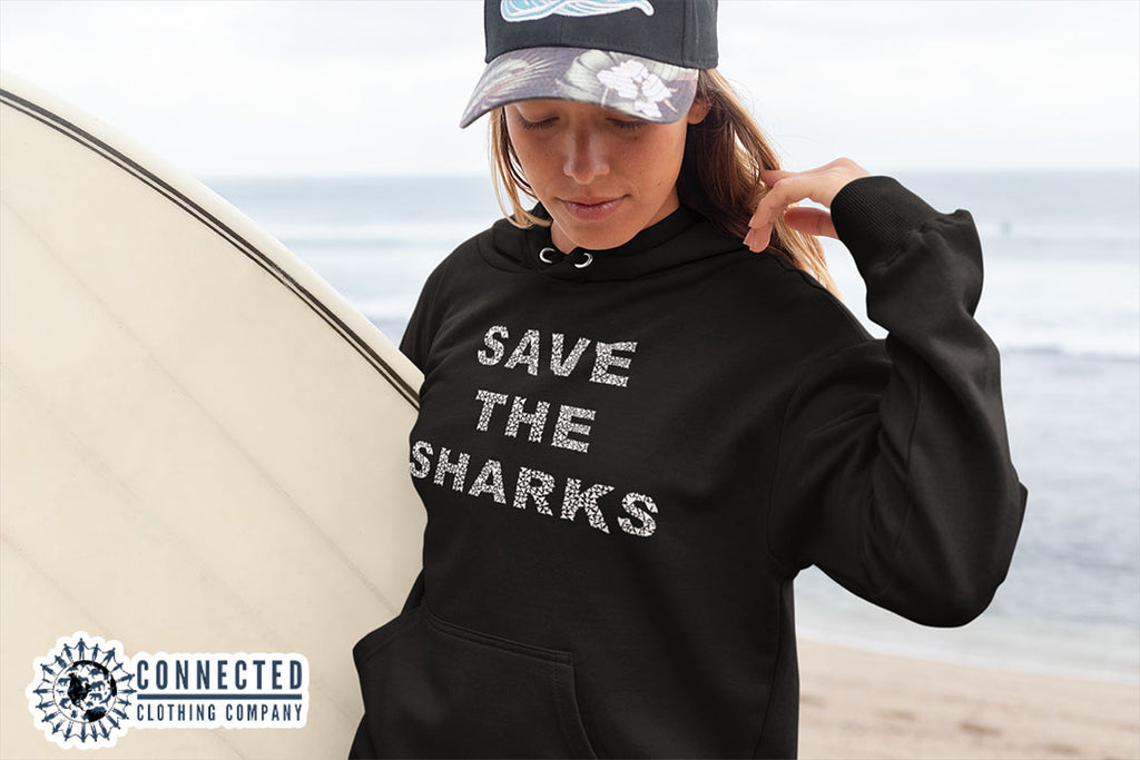woman on the beach wearing black Save The Sharks Unisex Hoodie - sweetsherriloudesigns - Ethically and Sustainably Made - 10% donated to Oceana shark conservation