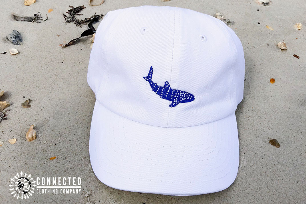 White Whale Shark Cotton Cap on beach sand - sweetsherriloudesigns - Ethically and Sustainably Made - 10% donated to Mission Blue ocean conservation